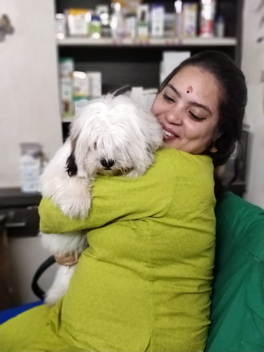 Dr. Pooja Hirulkar smiling with a patient at the clinic
