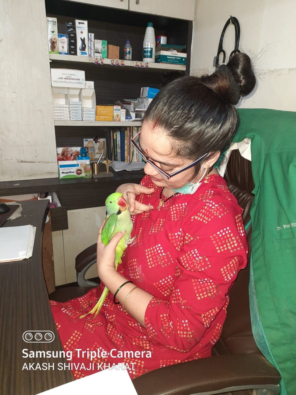 Dr. Pooja Hirulkar holding a pet parrot